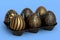 Golden and black Easter eggs in basket or tray and chocolate eggs