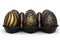 Golden and black Easter eggs in basket or tray and chocolate eggs