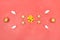 Golden bow, star, bell and ball on pink living coral background for birthday, christmas or wedding ceremony