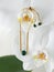 Golden bracelet with green malachite gems on orchid flower