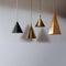 Golden brass pendant lamps against gray plain background. Minimalist style. Generative AI