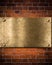 Golden or bronze plate on brick wall