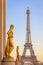 Golden bronze statues on Trocadero square, Eiffel tower, Paris France