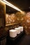 Golden brown design water closet room with bronze color tile on a wall and big mirror three sinks