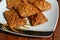 Golden brown fried Tempe on a patterned white plate