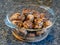 Golden brown meatballs in a glass bowl on a dark granite countertop