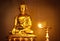 Golden Buddha with oil lamp