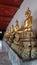 Golden Buddha sculpture in cloister around Ubosod in Wat Pho temple Bangkok Thailand