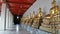 Golden Buddha sculpture in cloister around Ubosod in Wat Pho temple Bangkok Thailand