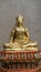 Golden Buddha sculpture on colourful glass base