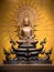 Golden Buddha sculpture in lotus position sitting