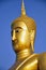 Golden Buddha soaring into blue sky
