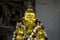 Golden buddha statue with flower rings