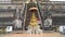 Golden Buddha statue in front of the Wat Chedi Luang, two sculptures of Dragons and