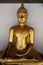 Golden Buddha statue inside Asian temple
