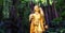 Golden Buddha statue and small artificial waterfall at the Golden Mount at Wat Saket in Bangkok, Thailand