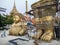 Golden Buddha statue in two parts ready to be assembled in buddhist temple yard in Thailand