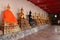 Golden Buddha statues decorate a gallery of a temple (Thailand)