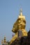 Golden buddhism pagoda on big stone