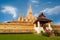 Golden buddhist pagoda of Phra That Luang Temple under blue sky. Vientiane, Laos