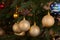 Golden bulbs on christmas tree close up