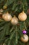 Golden bulbs on new year tree close up