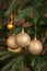Golden bulbs on new year tree close up