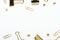 Golden buttons, paper clips and stationery clips on a white background. Frame of office stationery. Copy space, top view