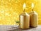 Golden candles. Gold glittering christmas lights. Blurred abstract background