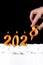 Golden candles write numbers flame Happy new year 2028 hand