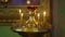 A golden candlestick with burning candles in the church on the altar.