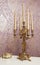 Golden candlestick with five candles on white table