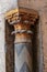 Golden capital of a small decorative column with engraved floral inscriptions at the ancient mosque of Sultan Hassan, Cairo, Egypt