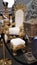 Golden chair with white velvet cushions next to a festively decorated Christmas tree and gifts decoration at Christmas market for