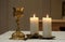 Golden chalice and burning candles