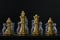 Golden chess are facing silver chess on black background. Business strategy, business competition, challenge or teamwork concept