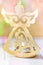 Golden Christmas angel candle holder, glitter background with colorful confetti lights, greeting card, poster