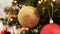 Golden christmas ball decoration on fir tree