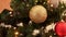 golden christmas ball decoration on fir tree