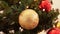 golden christmas ball decoration on fir tree