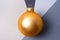 Golden Christmas ball at the intersection of four shades of gray.