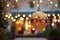 Golden Christmas balloon with decorated pines branches on the background of an illuminated winter street. Merry Christmas. Happy