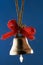 Golden Christmas bell with red ribbons