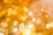 Golden Christmas Bokeh Background. Gold Holiday glowing Abstract Glitter Defocused