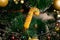 Golden Christmas decorations on a green artificial Christmas tree. Making a festive Christmas. Funny cute toys and gifts