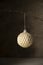 Golden Christmas ornament bauble sparkling decorative ball hanging, dark, moody background, copy space