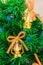 Golden Christmas tree bells and lanterns with bows on an artificial Christmas tree