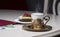 Golden coffee cup, fruits cake and cash 100 euro on table in cafe, luxurious elegance style