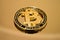 Golden coin bitcoin cryptocurrency on a mirrored surface