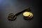 Golden coins with key, key to money, om dark background